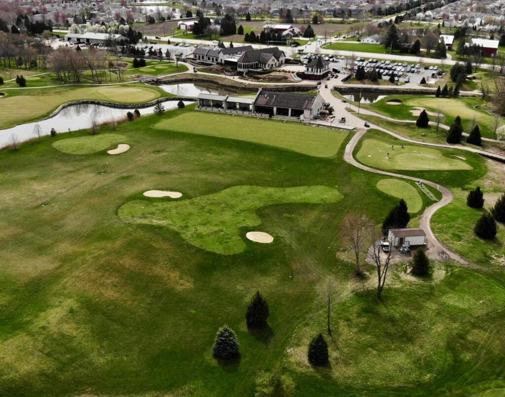 Aerial view of Mistwood Golf Club’s short game practice greens, bunkers, and putting area.