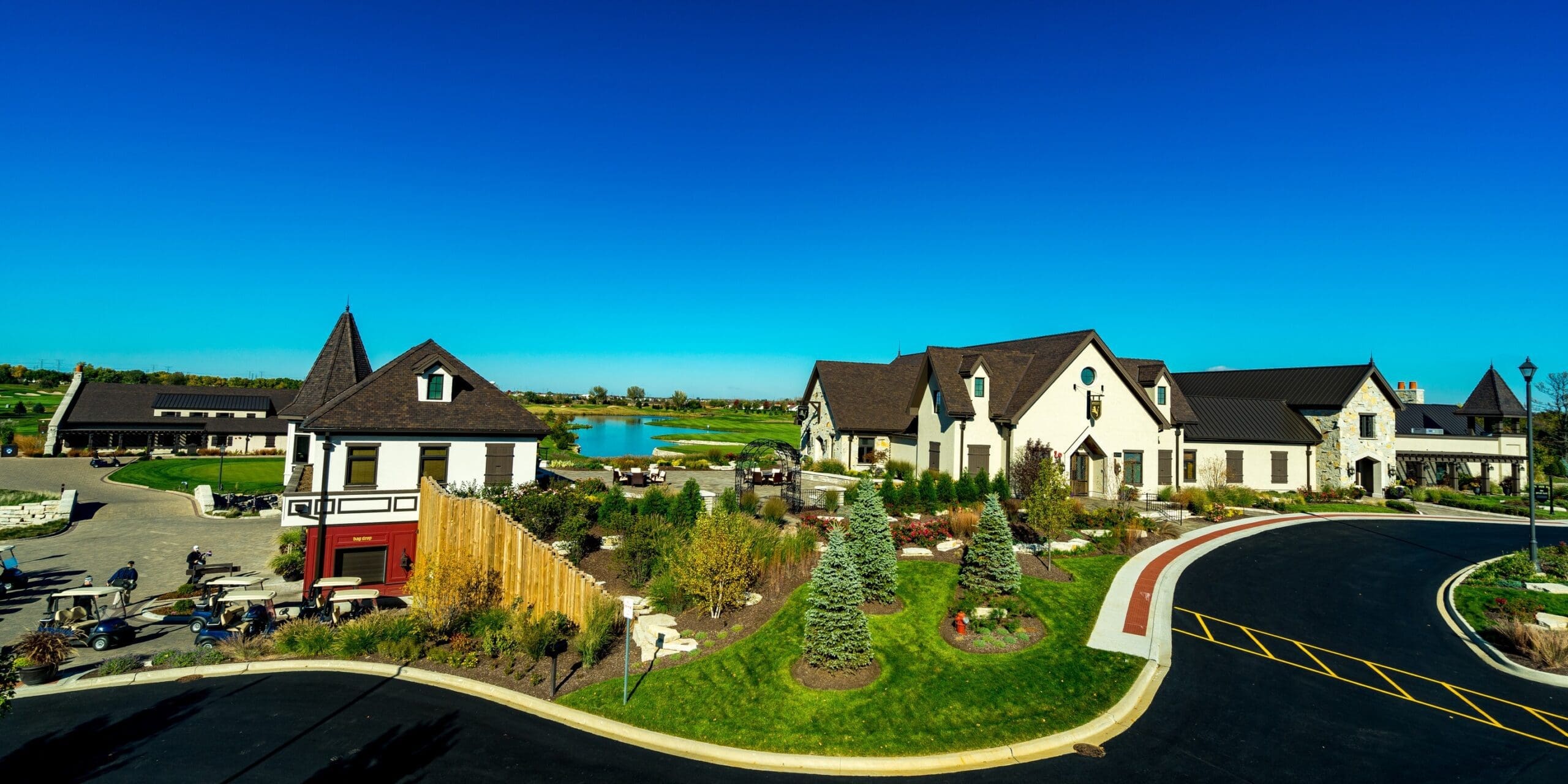 Full-color aerial view of Mistwood Golf Club campus with buildings, water, and greenery.