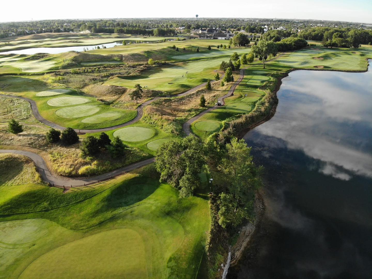 Aerial view of Mistwood Golf Club in Romeoville, Illinois, showcasing championship-level fairways, multiple tee boxes, and scenic lakefront holes designed for premium golf experiences.